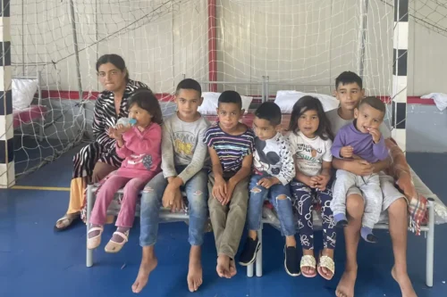 Kids who lost their homes, waiting in a sports hall for the next steps.