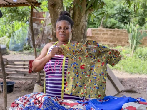 Products on display "Women participating in the Ghana Sewing Project proudly display their handmade garments, symbolizing their newfound financial independence achieved through microfinance initiatives."